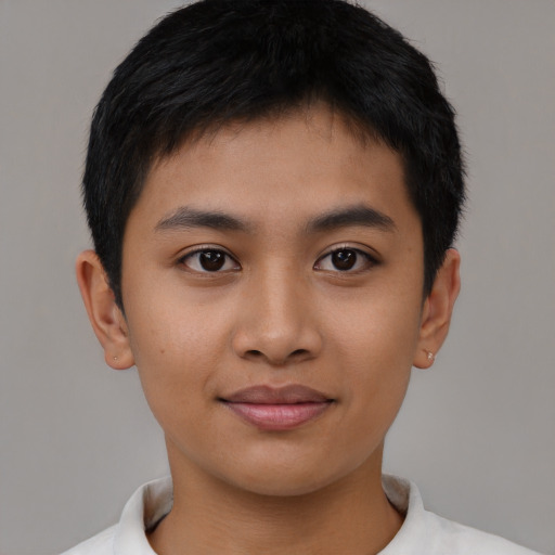 Joyful asian young-adult male with short  brown hair and brown eyes