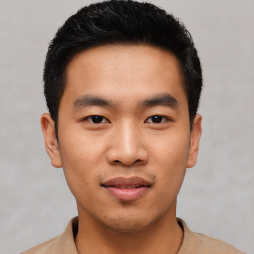 Joyful asian young-adult male with short  black hair and brown eyes