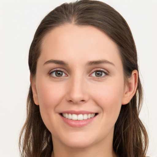 Joyful white young-adult female with long  brown hair and grey eyes