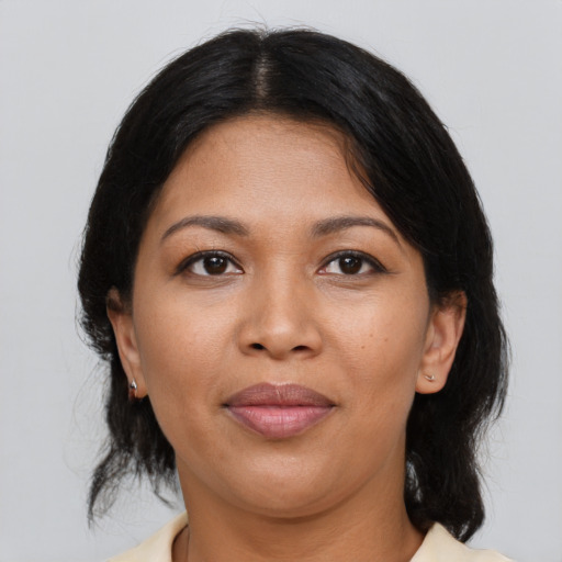 Joyful latino young-adult female with medium  black hair and brown eyes