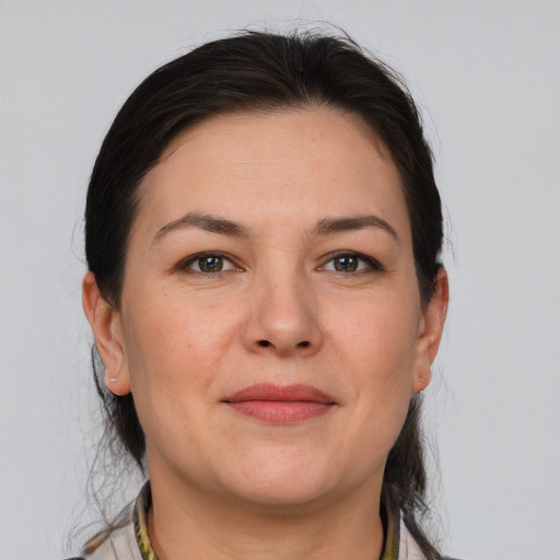 Joyful white adult female with medium  brown hair and brown eyes