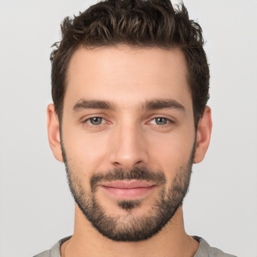 Joyful white young-adult male with short  black hair and brown eyes