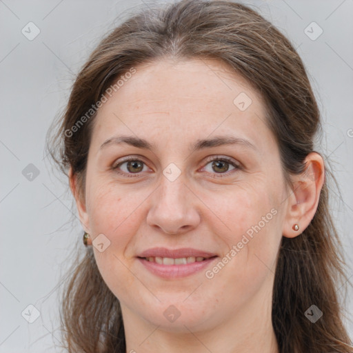 Joyful white adult female with long  brown hair and brown eyes