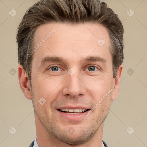 Joyful white adult male with short  brown hair and grey eyes