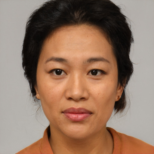 Joyful asian adult female with short  brown hair and brown eyes