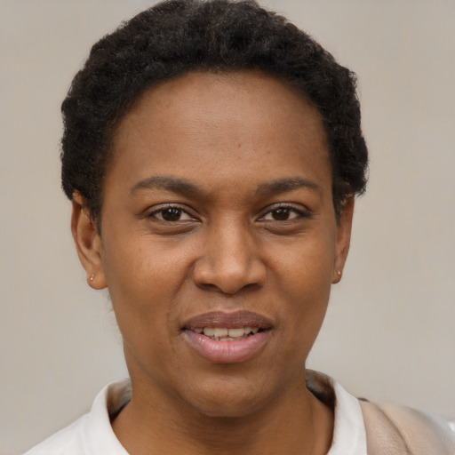Joyful black young-adult female with short  brown hair and brown eyes