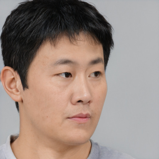 Neutral asian young-adult male with short  brown hair and brown eyes