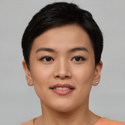 Joyful asian young-adult female with short  brown hair and brown eyes