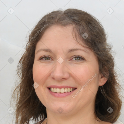 Joyful white adult female with medium  brown hair and grey eyes