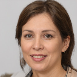 Joyful white adult female with medium  brown hair and brown eyes