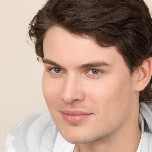 Joyful white young-adult male with medium  brown hair and brown eyes