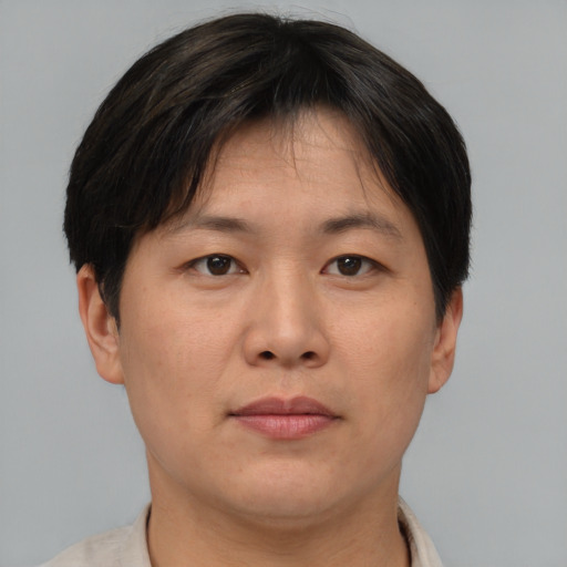 Neutral asian adult female with short  brown hair and brown eyes