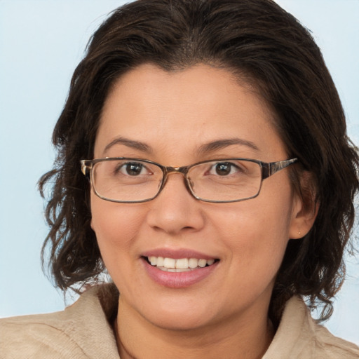 Joyful white adult female with medium  brown hair and brown eyes