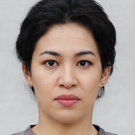 Joyful asian young-adult female with medium  black hair and brown eyes