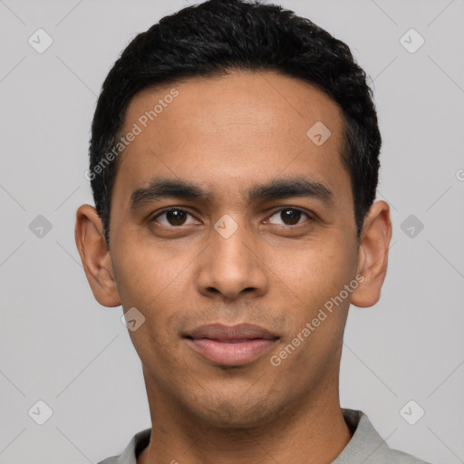 Joyful latino young-adult male with short  black hair and brown eyes