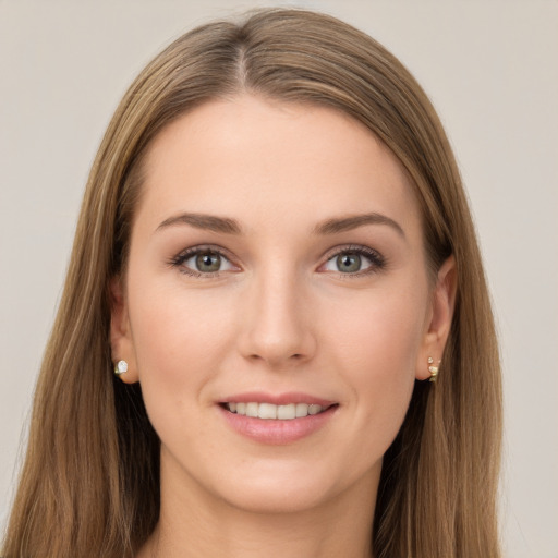 Joyful white young-adult female with long  brown hair and grey eyes