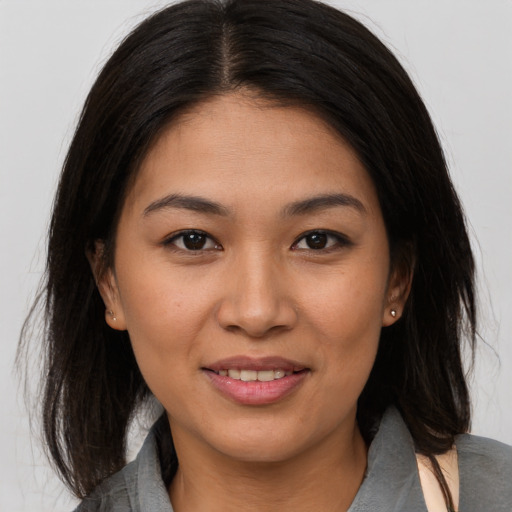 Joyful asian young-adult female with medium  brown hair and brown eyes