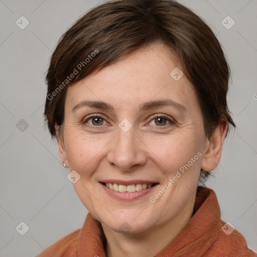 Joyful white adult female with short  brown hair and grey eyes