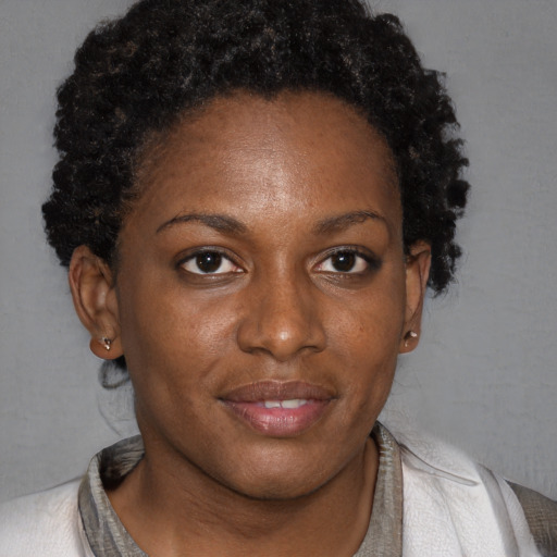 Joyful black young-adult female with short  brown hair and brown eyes