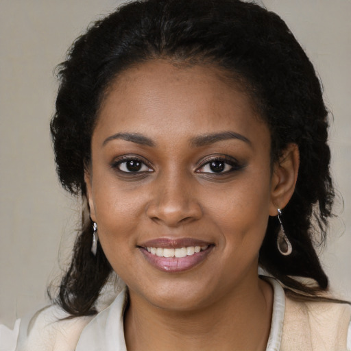 Joyful black young-adult female with medium  brown hair and brown eyes