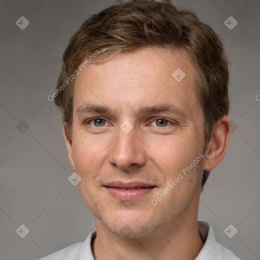 Joyful white young-adult male with short  brown hair and grey eyes