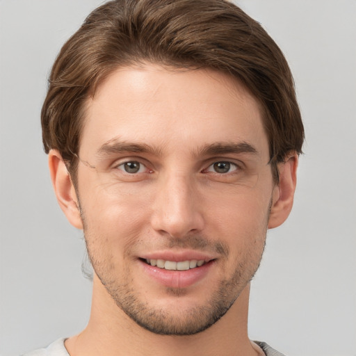 Joyful white young-adult male with short  brown hair and grey eyes