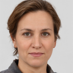 Joyful white adult female with medium  brown hair and grey eyes