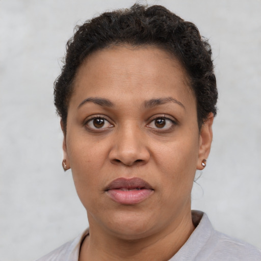 Joyful latino adult female with short  brown hair and brown eyes