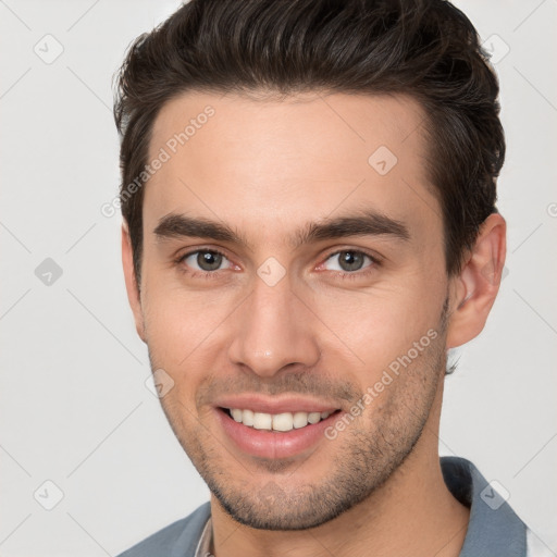 Joyful white young-adult male with short  brown hair and brown eyes