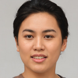 Joyful asian young-adult female with short  brown hair and brown eyes