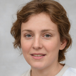 Joyful white young-adult female with medium  brown hair and green eyes