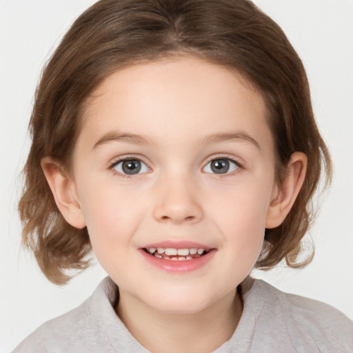 Joyful white child female with medium  brown hair and grey eyes