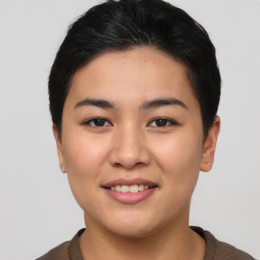 Joyful asian young-adult female with short  black hair and brown eyes