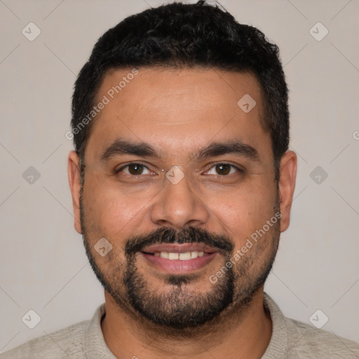 Joyful latino young-adult male with short  black hair and brown eyes