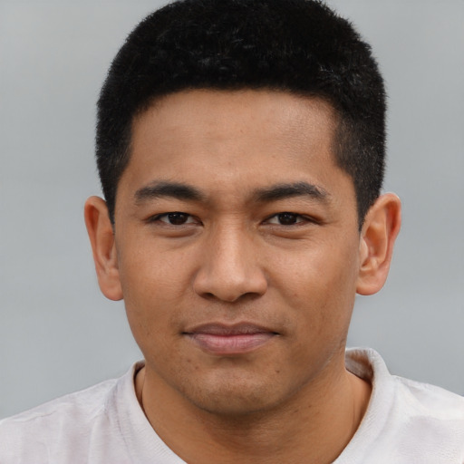 Joyful asian young-adult male with short  brown hair and brown eyes