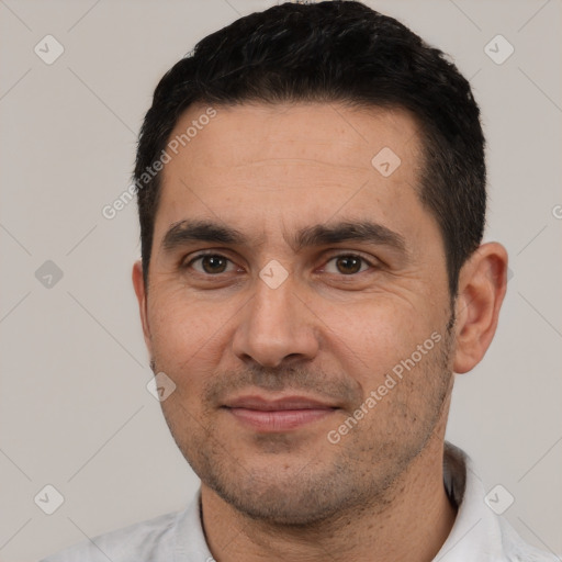 Joyful white adult male with short  black hair and brown eyes