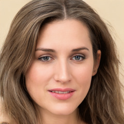 Joyful white young-adult female with long  brown hair and green eyes