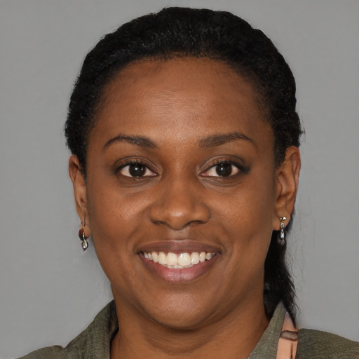 Joyful black young-adult female with medium  black hair and brown eyes