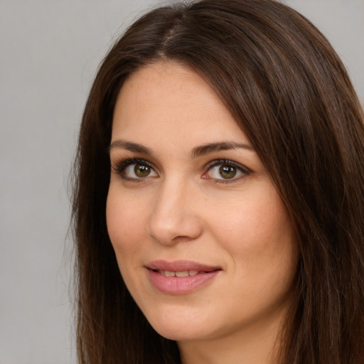 Joyful white young-adult female with long  brown hair and brown eyes