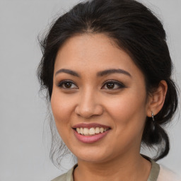 Joyful latino young-adult female with medium  brown hair and brown eyes