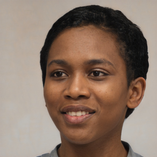 Joyful black young-adult female with short  black hair and brown eyes