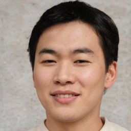 Joyful asian young-adult male with short  brown hair and brown eyes