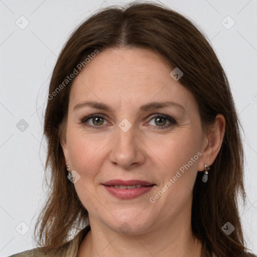 Joyful white adult female with long  brown hair and grey eyes