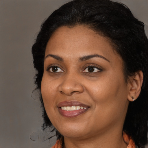 Joyful black young-adult female with medium  black hair and brown eyes