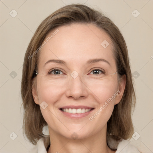 Joyful white adult female with medium  brown hair and grey eyes