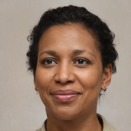 Joyful black adult female with medium  brown hair and brown eyes