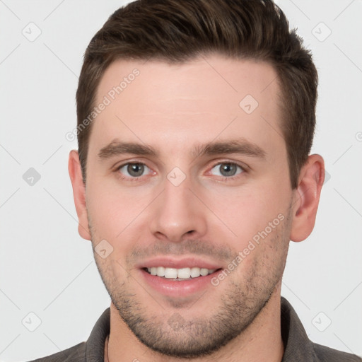 Joyful white young-adult male with short  brown hair and grey eyes