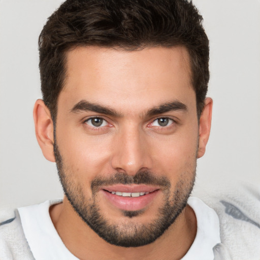 Joyful white young-adult male with short  brown hair and brown eyes