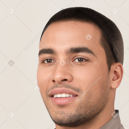 Joyful white young-adult male with short  black hair and brown eyes