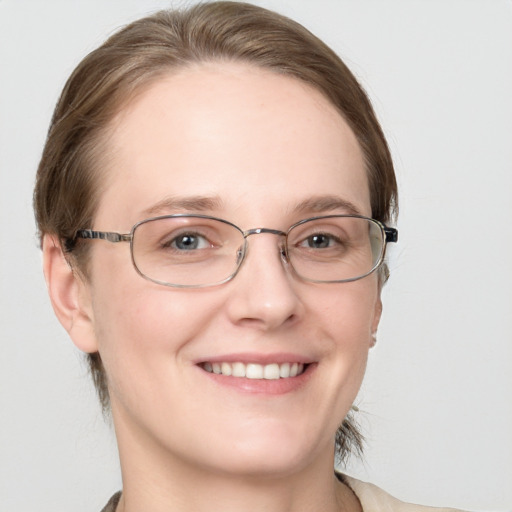 Joyful white young-adult female with medium  brown hair and blue eyes